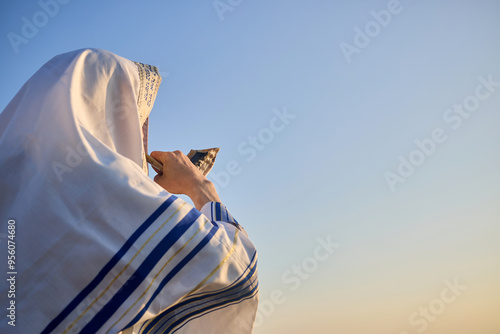 Slika na platnu Jewish man blowing the Shofar rams horn on Rosh Hashanah and Yom Kippur day