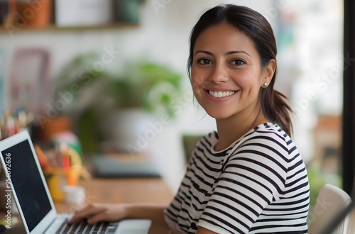 Portrait of a happy smiling businesswoman sitting at her desk with a laptop,headshot