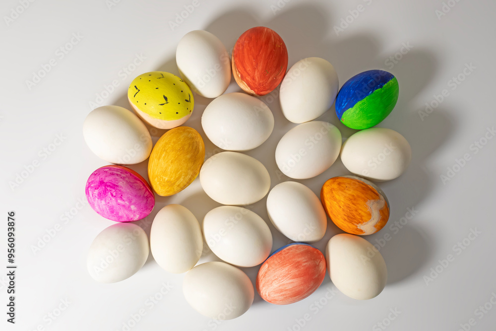 Obraz premium Colorful Easter eggs on white surface during Easter celebration. Happy easter.