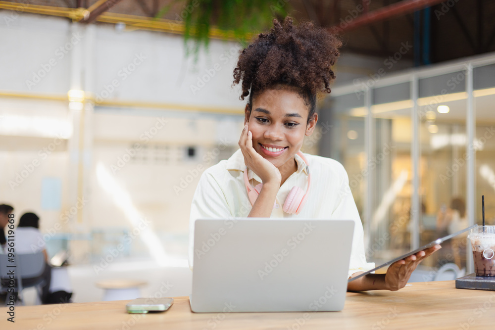 African American young woman using laptop. African American young woman using laptop.