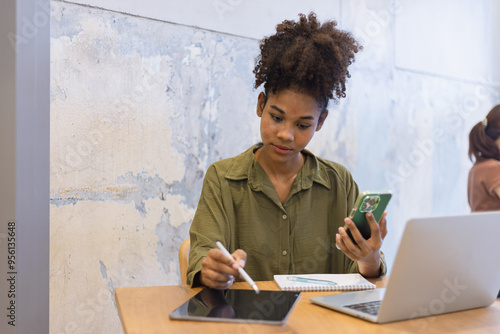 African American woman with smartphone, excited woman.  photo