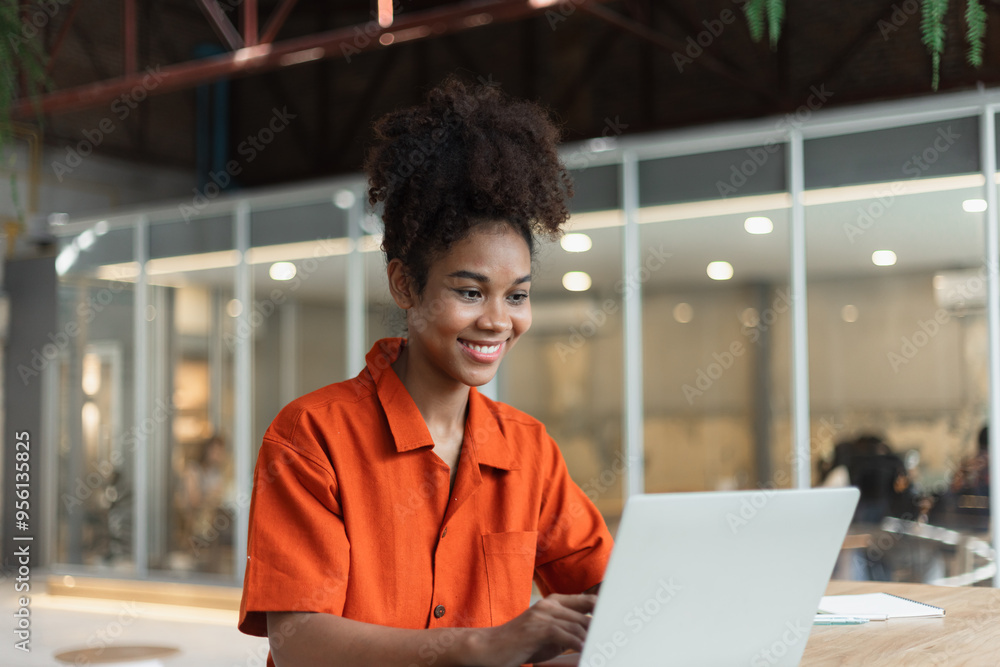 About successful young woman concept. Excited African American woman sitting at working desk. About successful young woman concept. Excited African American woman sitting at working desk.