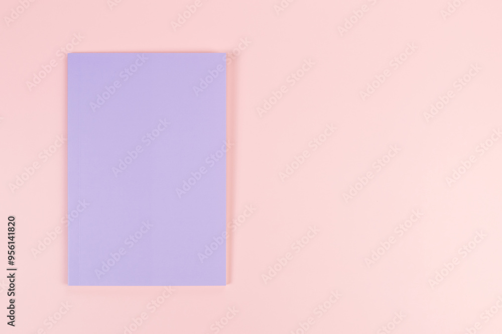 Top view of purple notebook on pink background. School, office wallpaper. Flat lay, copy space. Top view of purple notebook on pink background. School, office wallpaper. Flat lay, copy space.