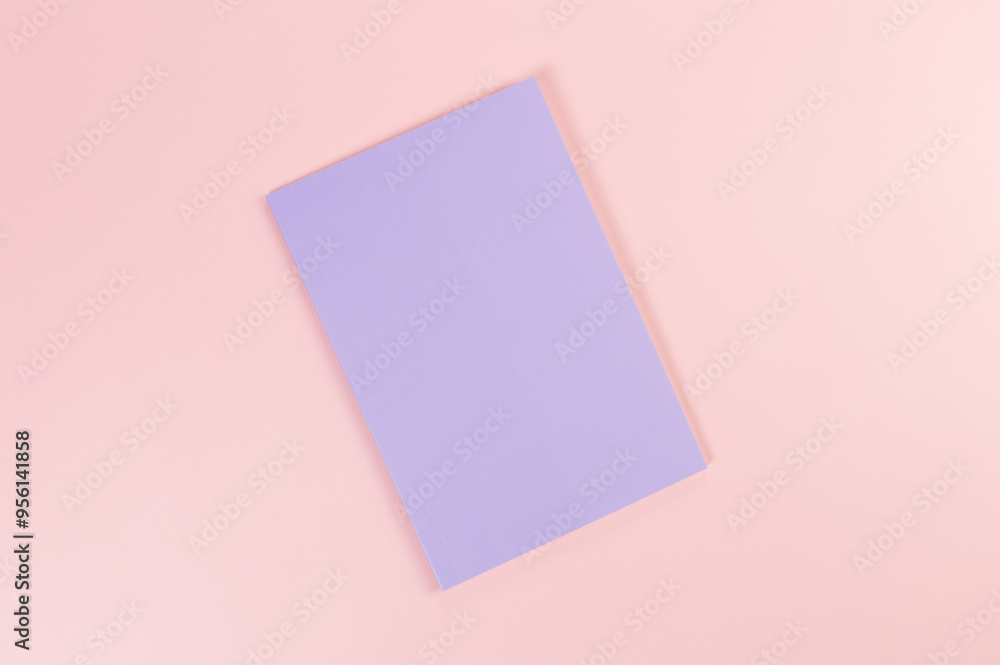 Top view of purple notebook on pink background. School, office wallpaper. Flat lay, copy space. Top view of purple notebook on pink background. School, office wallpaper. Flat lay, copy space.