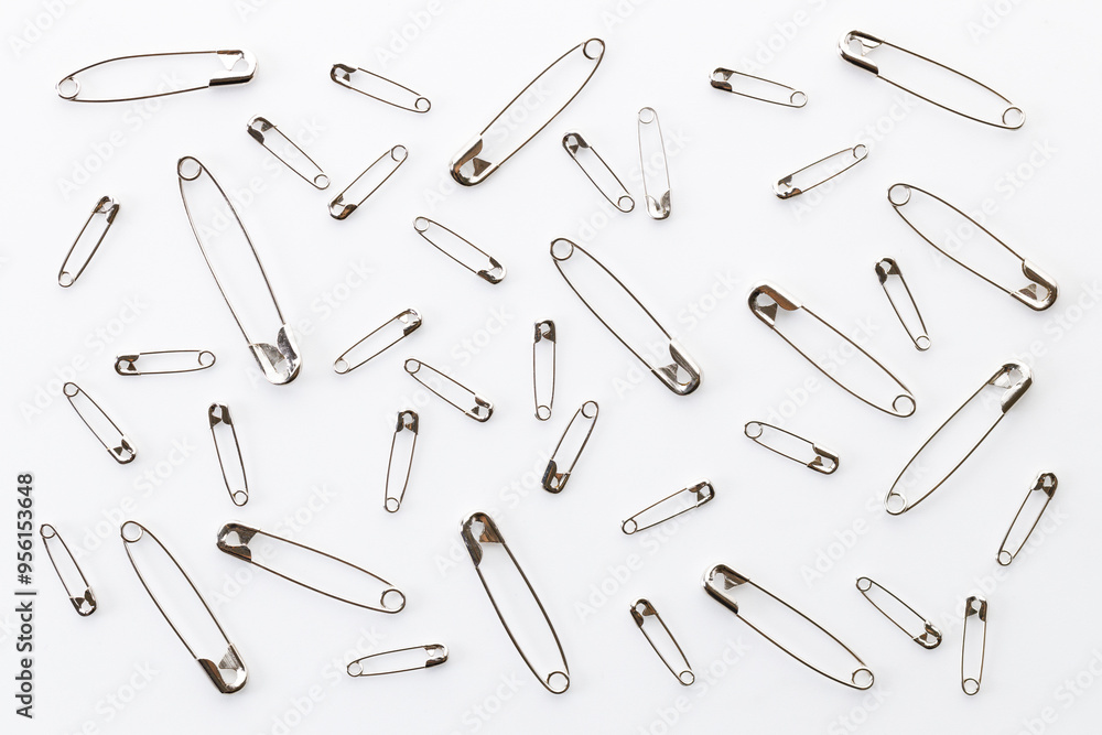 Set of big and small size silver safety pins. Set of big and small size silver safety pins.