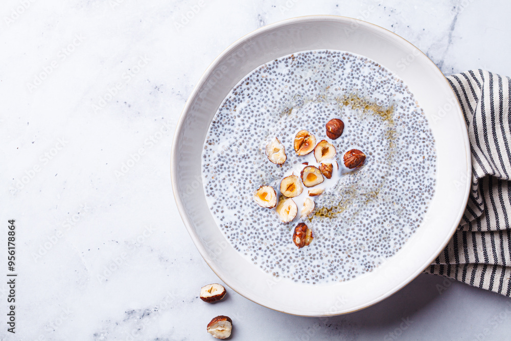 Chia pudding with hazelnuts and maple syrup, white background. Chia pudding with hazelnuts and maple syrup, white background.
