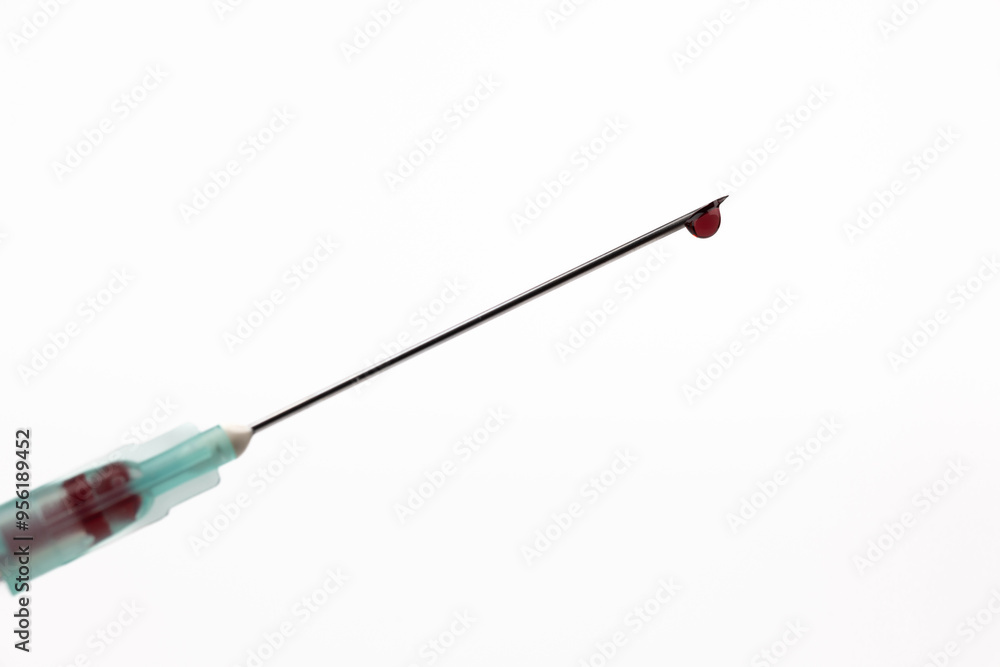 Fototapeta premium Close-Up of Syringe Needle with Blood Drop Centered
