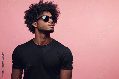 Afro American man in black shirt and sunglasses isolated against pink background. High quality photo