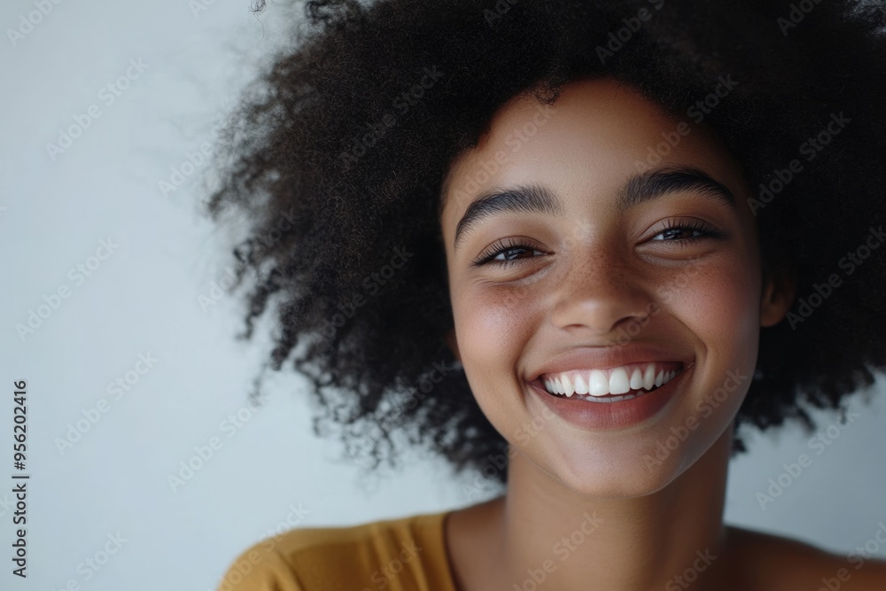 Happy young student with Afro laughing at camera. Happy young student with Afro laughing at camera.