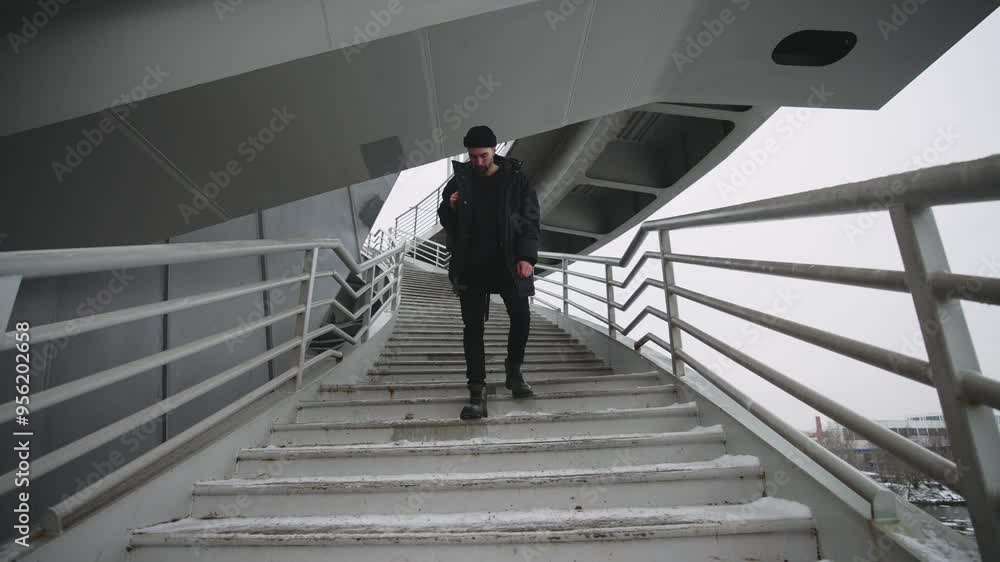 Cinematic portrait of handsome bearded man in urbanscape, standing on stairs. Zooming shot to male face, headshot of depressed and exhausted person holding backpack and looking at camera, slow motion Cinematic portrait of handsome bearded man in urbanscape, standing on stairs. Zooming shot to male face, headshot of depressed and exhausted person holding backpack and looking at camera, slow motion