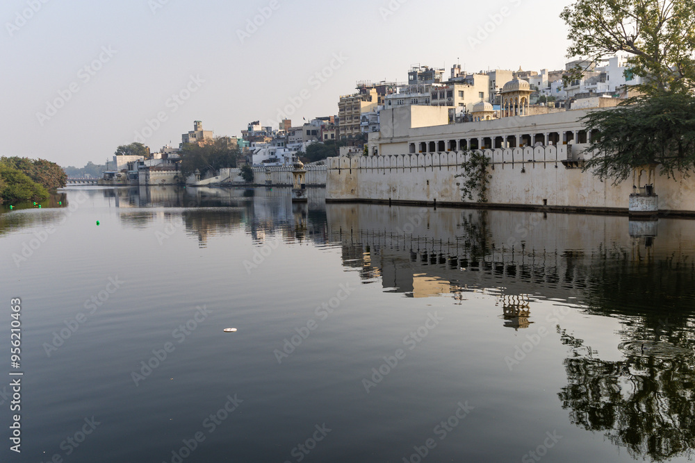 Tranquil Waterfront View of Udaipur Cityscape with Historic Architecture and Reflections Tranquil Waterfront View of Udaipur Cityscape with Historic Architecture and Reflections