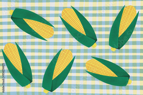 Paper corn cobs on checkered tablecloth photo