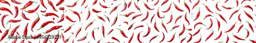 Isolated red hot chilli peppers falling on a white background, selective focus