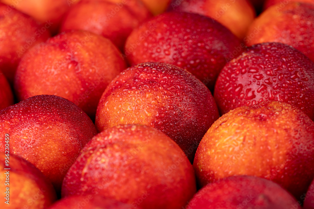ripe wet red nectarines folded together