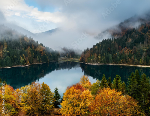 Tranquil Blue Lake Between Lush Forests and Mountains