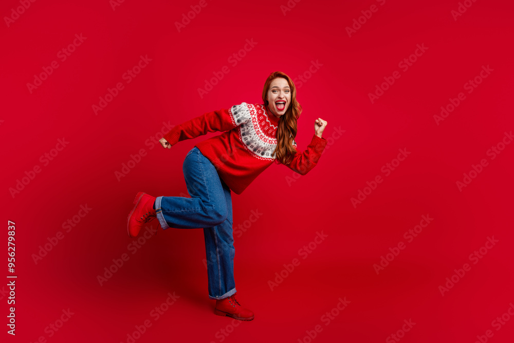 Full body length photo of young funky redhair lady dancing wearing seasonal sweater and jeans clubbing isolated on red color background Full body length photo of young funky redhair lady dancing wearing seasonal sweater and jeans clubbing isolated on red color background