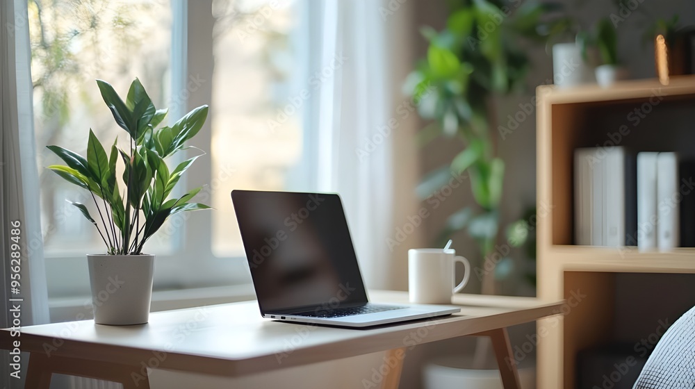A clean and organized home office setup, featuring a sleek laptop, a cup of coffee, and a minimalist desk with a potted plant. A clean and organized home office setup, featuring a sleek laptop, a cup of coffee, and a minimalist desk with a potted plant.