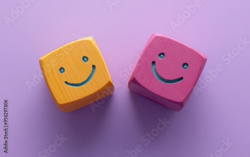 Two wooden blocks with smiley faces on a purple background