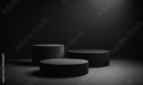 Three black podiums on a dark surface, lit by a spotlight overhead
