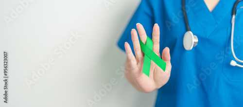 Schilderij op canvas Doctor with green Ribbon for world Lymphoma Awareness September month, world Mental Health Day, Liver, Gallbladders, bile duct, cervical, kidney Cancer