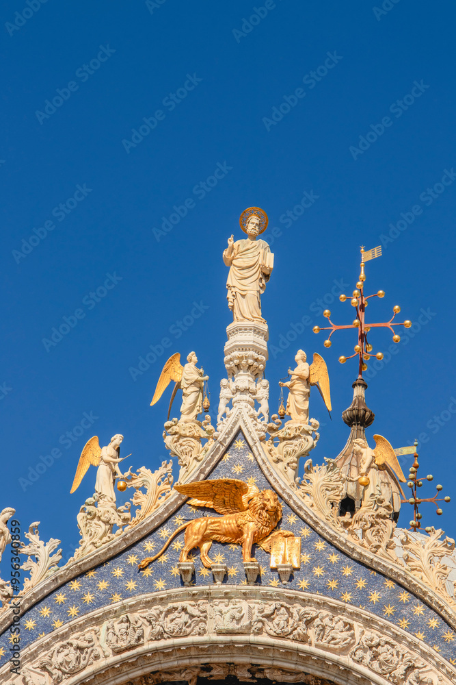 Basilica di San Marco or St Mark's Basilica, Venice, Italy. It is the main travel attraction of Venice. Luxury facade of St Mark's church close-up. Ornate detail of landmark of Venice in summer.