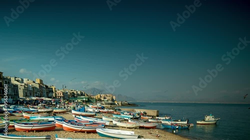 fishing boats and fishermen on the beach in the town of Aspra, sicily photo