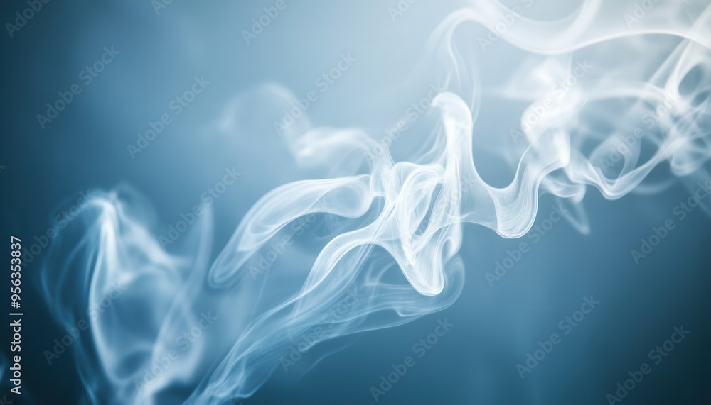 Fototapeta premium A delicate swirl of smoke on a soft blue background, creating a serene and mystical atmosphere for various design projects.