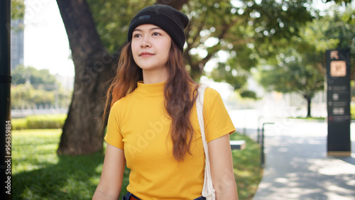 Go green Gen Z woman asia young people carrying eco tote mesh bag reuse walk in city nature tree public park save the earth planet world care. Reduce issues asian hope net zero waste the way forward. photo