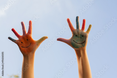 Children's painted hands with smiling faces. Happiness, joy, education, creative, school concept