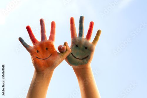 Children's painted hands with smiling faces. Happiness, joy, education, creative, school concept