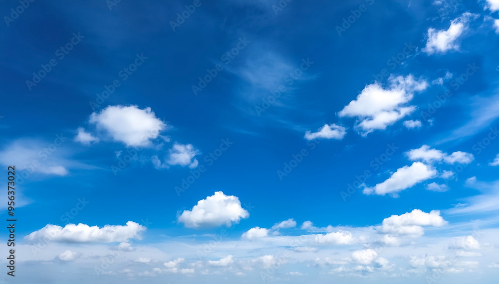 Blue sky with a few clouds. The sky is very bright and the clouds are scattered throughout Blue sky with a few clouds. The sky is very bright and the clouds are scattered throughout