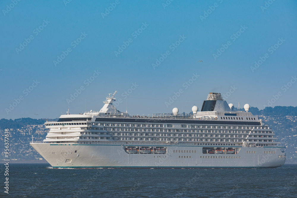 Luxury cruiseship cruise ship liner Serenity sail away departure from San Francisco port through bay towards Golden Gate Bridge on sunny day Luxury cruiseship cruise ship liner Serenity sail away departure from San Francisco port through bay towards Golden Gate Bridge on sunny day