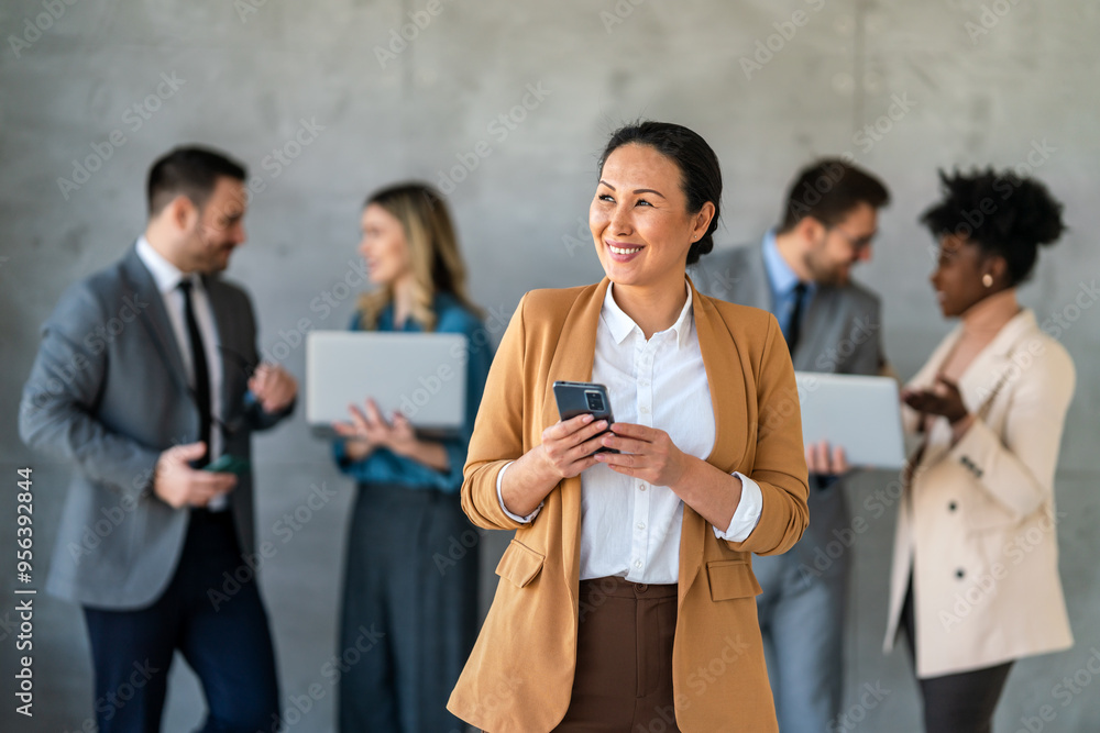 Portrait of successful business woman, entrepreneur while multiethnic colleagues working background. Portrait of successful business woman, entrepreneur while multiethnic colleagues working background.