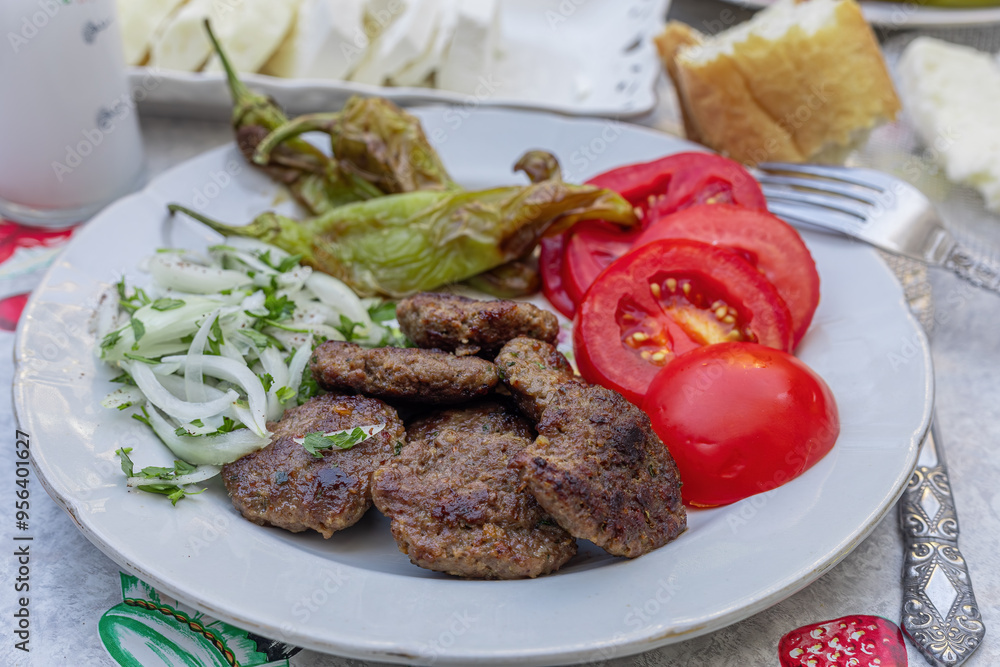 The famous Milas meatballs made by kneading tomatoes, onions, roasted peppers, lamb and beef on a plate