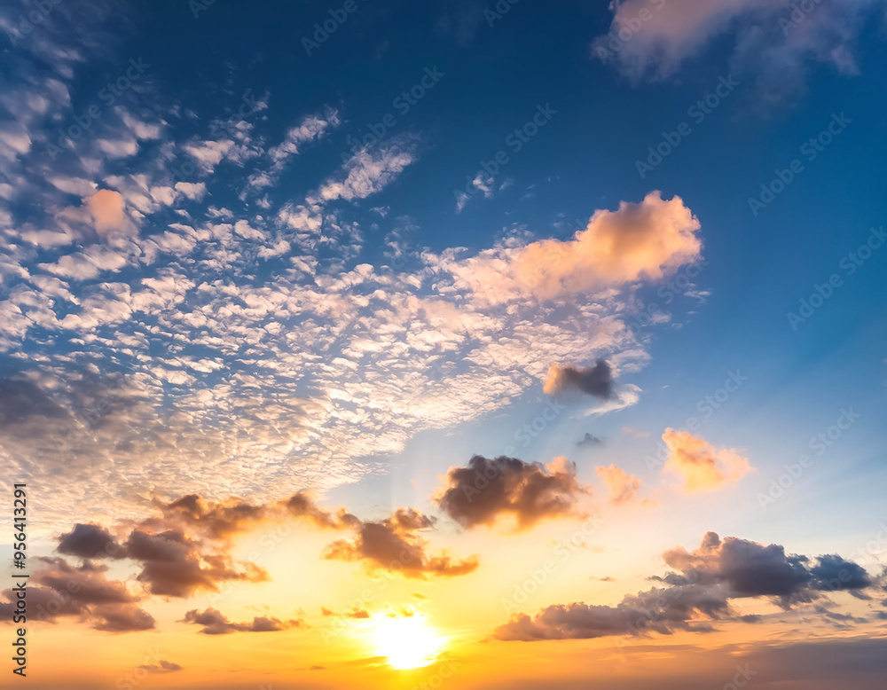 Sunset sky with a few clouds. The sky is very bright and the clouds are scattered throughout Sunset sky with a few clouds. The sky is very bright and the clouds are scattered throughout
