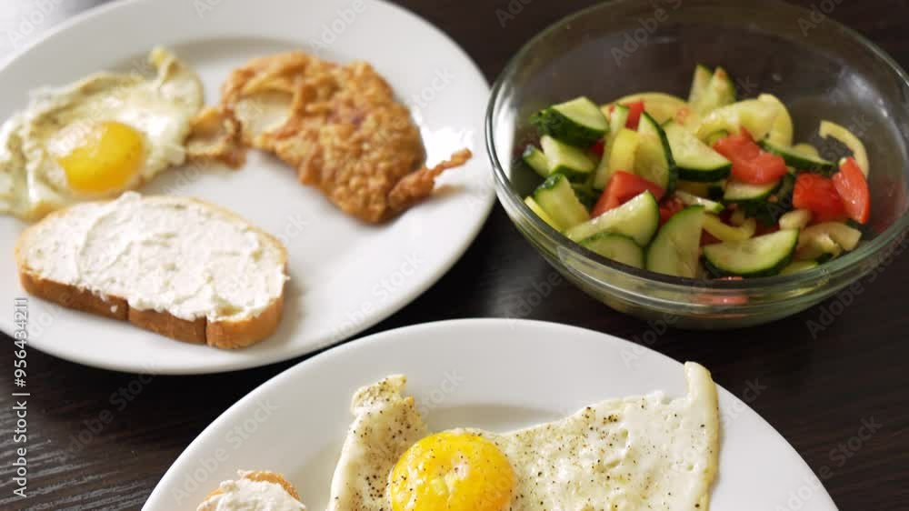 Breakfast fried eggs with salad and toast. Two servings Breakfast fried eggs with salad and toast. Two servings