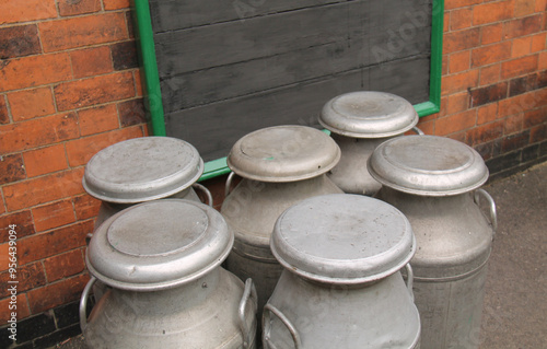 A Collection of Classic Milk Churns on a Railway Platform.