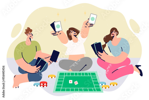 People play board game monopoly, sitting on floor and laughing, enjoying time together with friends