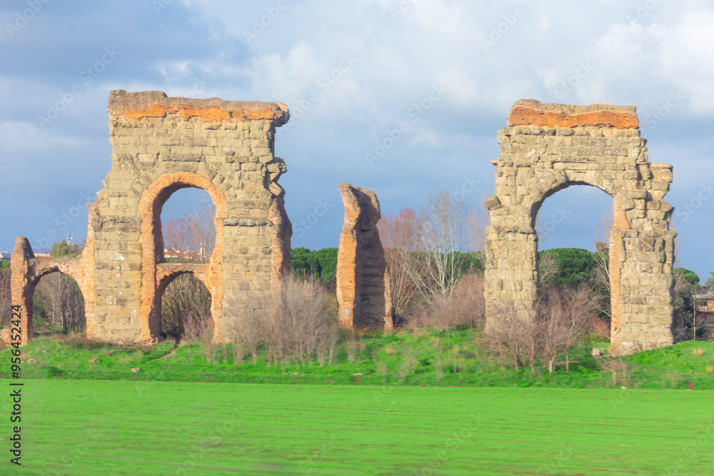 Roman aqueducts in Rome. Ancient Roman ruins and stone monuments at Via Appia Antica Roman aqueducts in Rome. Ancient Roman ruins and stone monuments at Via Appia Antica