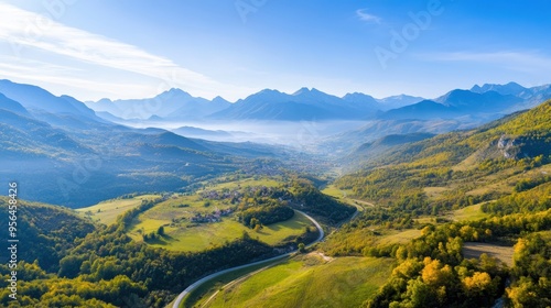 Aerial a mountainous region with winding roads and small villages nestled in the valleys, highlighting the rugged beauty of the terrain