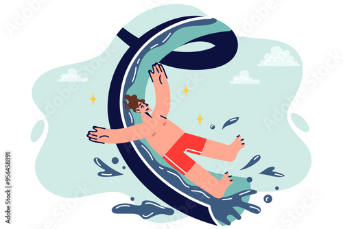 Man visitor to aquapark slides down high slide, enjoying summer holiday and opportunity to cool off