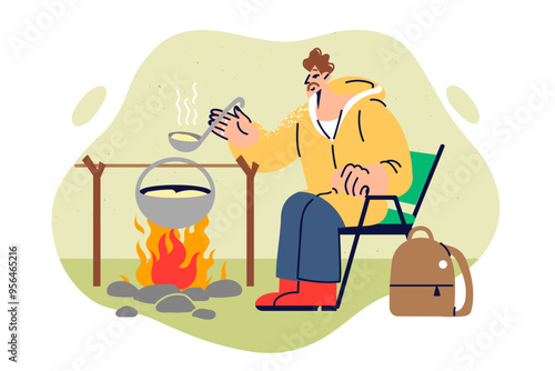 Camping and cooking by male traveler going on solo trek into wild for thrill or challenge