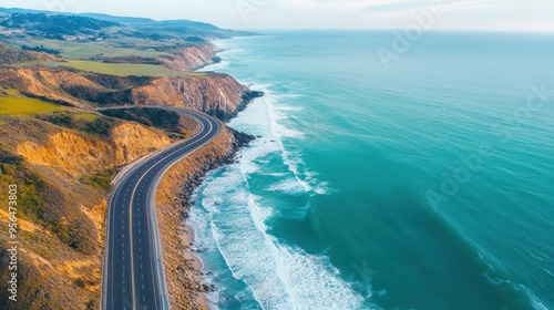 a dramatic coastline road, with cliffs rising on one side and the ocean stretching out on the other, waves crashing against the rocks below, captured in first person point of view