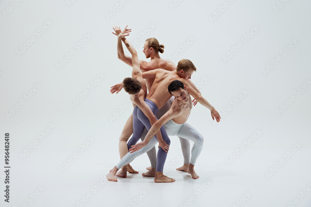 Group of dancers entwine their bodies in complex pose, capturing beauty of synchronized movement against white studio background. Concept of music and dance, modern and classical art. Group of dancers entwine their bodies in complex pose, capturing beauty of synchronized movement against white studio background. Concept of music and dance, modern and classical art.