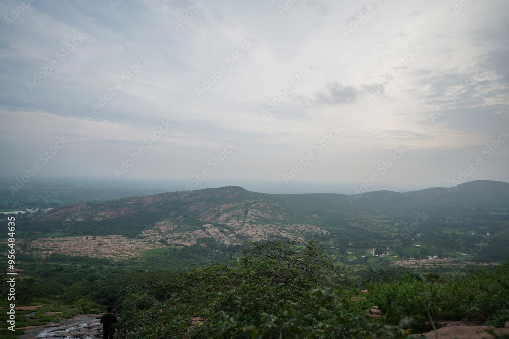 Aerial View of a Vast Landscape, Panoramic View of a Distant Valley, Scenic Landscape at Sunset Time, Misty Mountains and Rolling Hills Stock Photo. Aerial View of a Vast Landscape, Panoramic View of a Distant Valley, Scenic Landscape at Sunset Time, Misty Mountains and Rolling Hills Stock Photo.
