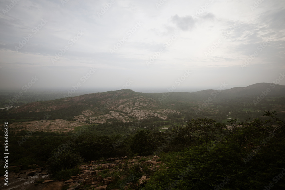 Aerial View of a Vast Landscape, Panoramic View of a Distant Valley, Scenic Landscape at Sunset Time, Misty Mountains and Rolling Hills Stock Photo. Aerial View of a Vast Landscape, Panoramic View of a Distant Valley, Scenic Landscape at Sunset Time, Misty Mountains and Rolling Hills Stock Photo.