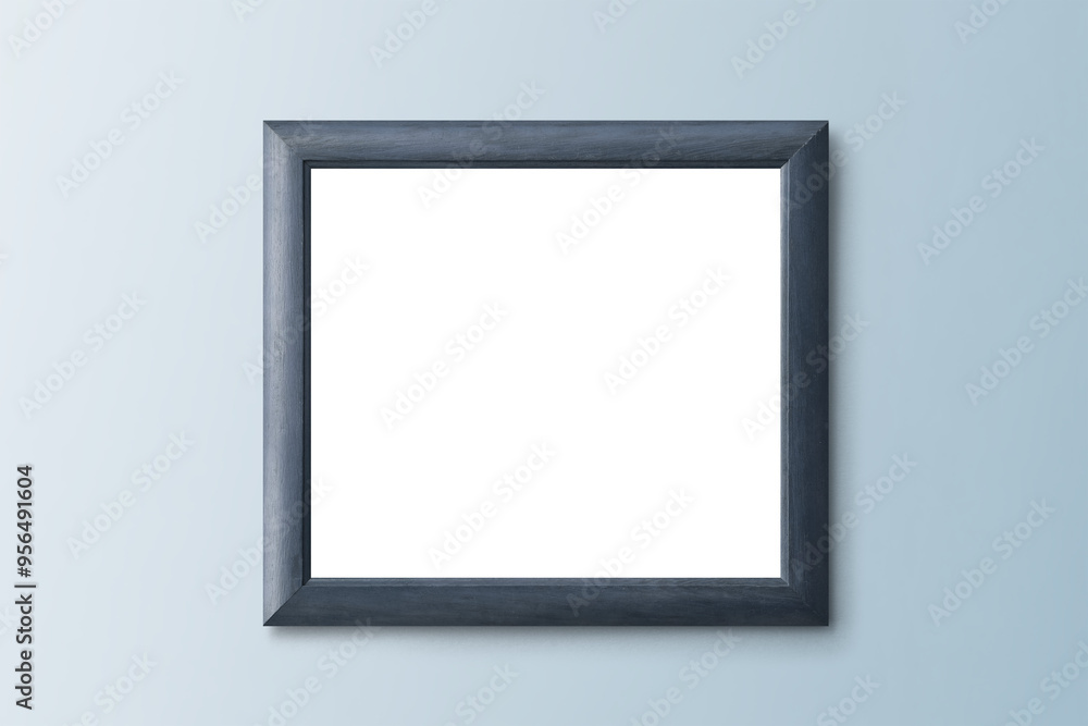 Bluish gray picture frame mockup hanging on a blue wall Bluish gray picture frame mockup hanging on a blue wall