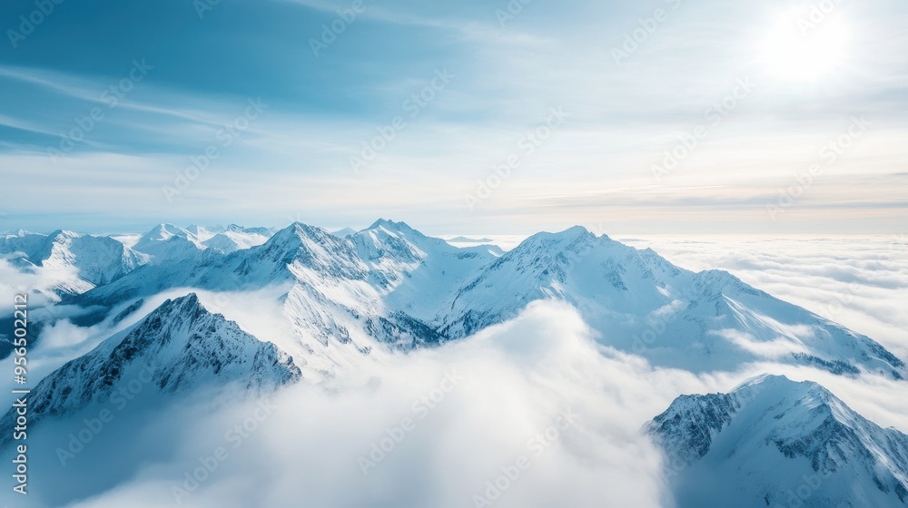 an aerial view of a mountain range with snow-capped peaks, deep valleys, and clouds drifting over the landscape, a majestic and awe-inspiring scene an aerial view of a mountain range with snow-capped peaks, deep valleys, and clouds drifting over the landscape, a majestic and awe-inspiring scene