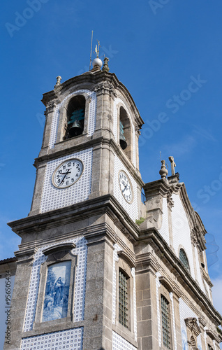 Sao Martinho de Lordelo church tower with clock and tiles decoration in Porto, Portugal. Vertical shot. photo