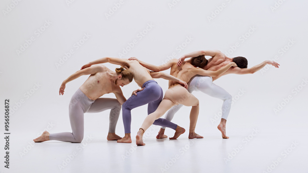 Naklejka premium Male ballet dancers captured in synchronized motion, showcasing their athleticism and grace in perfect dance against white studio background. Concept of music and dance, modern and classical art.